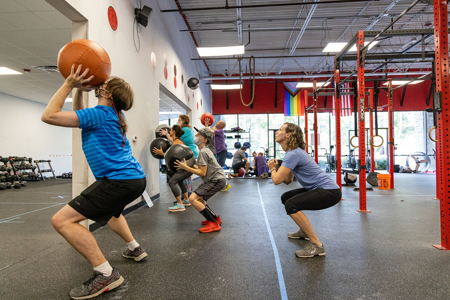 Athletes throw balls at the wall in a gym