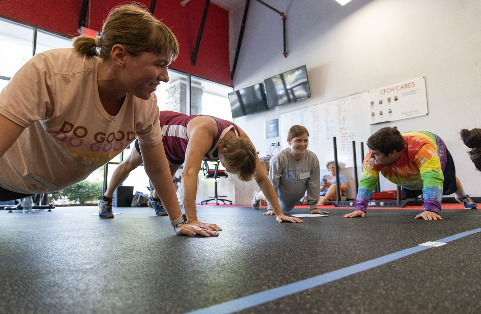 Athletes do pushups in a gym