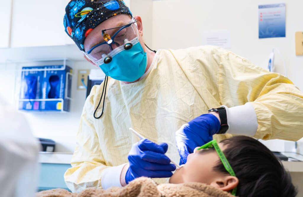 Pediatric dentist working on a child 
