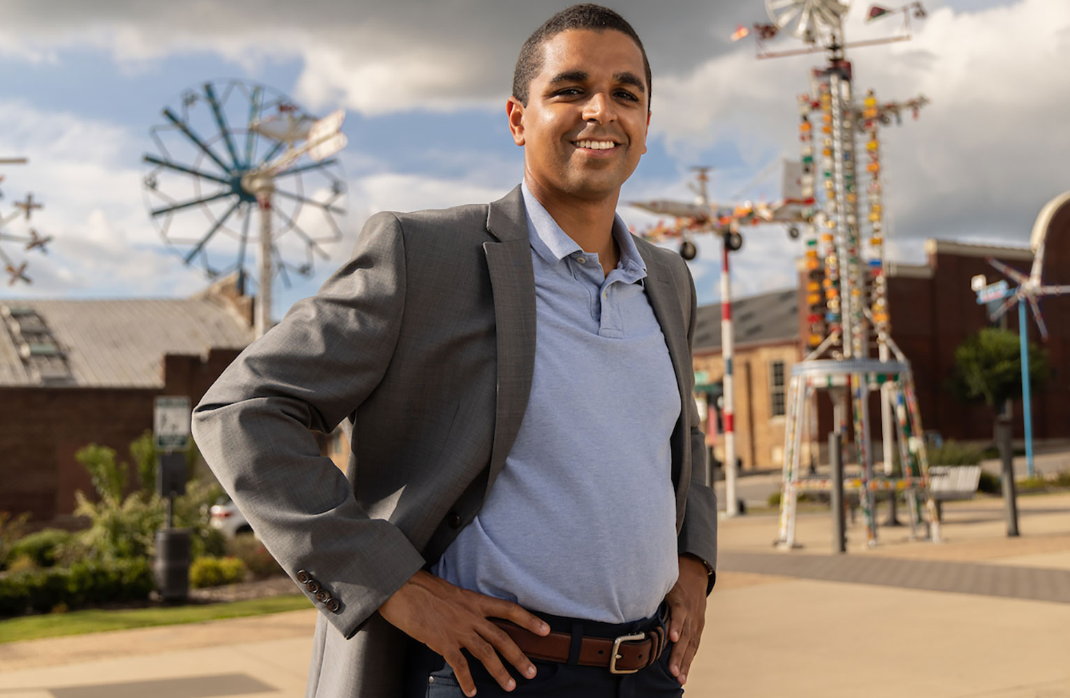 Dante Pittman stands with hand on hips with Whirligig Park in the background