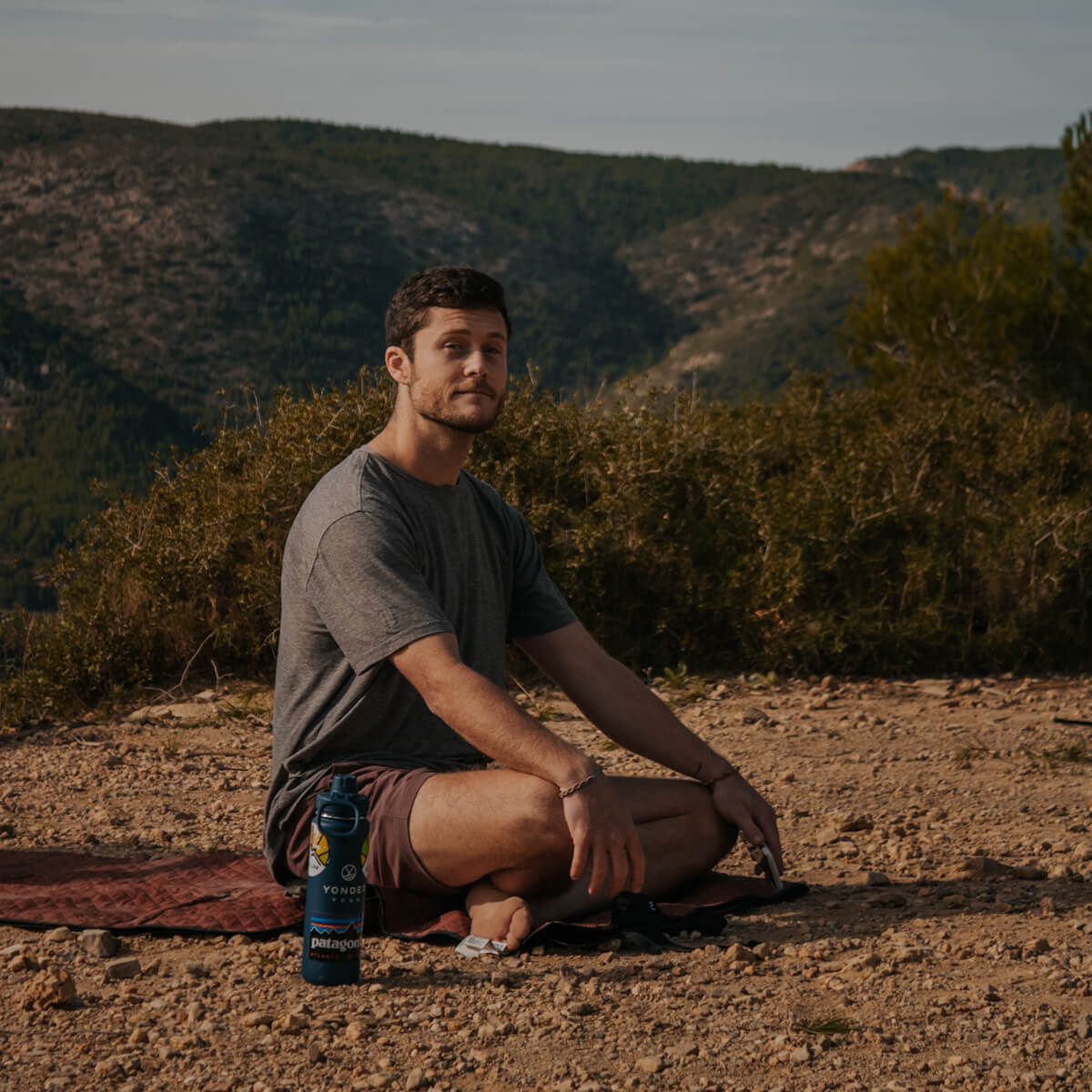 Drew Stockton sits cross-legged at a yoga class
