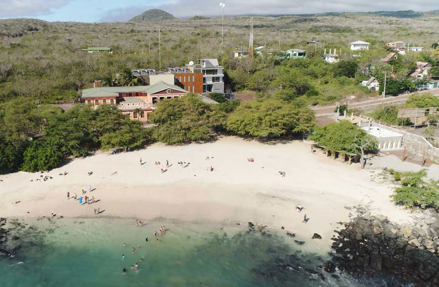 An aerial view of the Galapagos Science Center with beach and ocean in the foreground