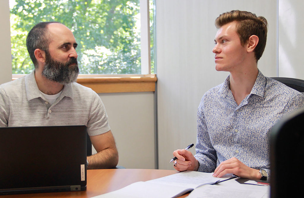 Daniel Bowen (right) meets with Ross Tompkins, assistant to the town manager, to discuss Chapel Hill's sustainability initiative.