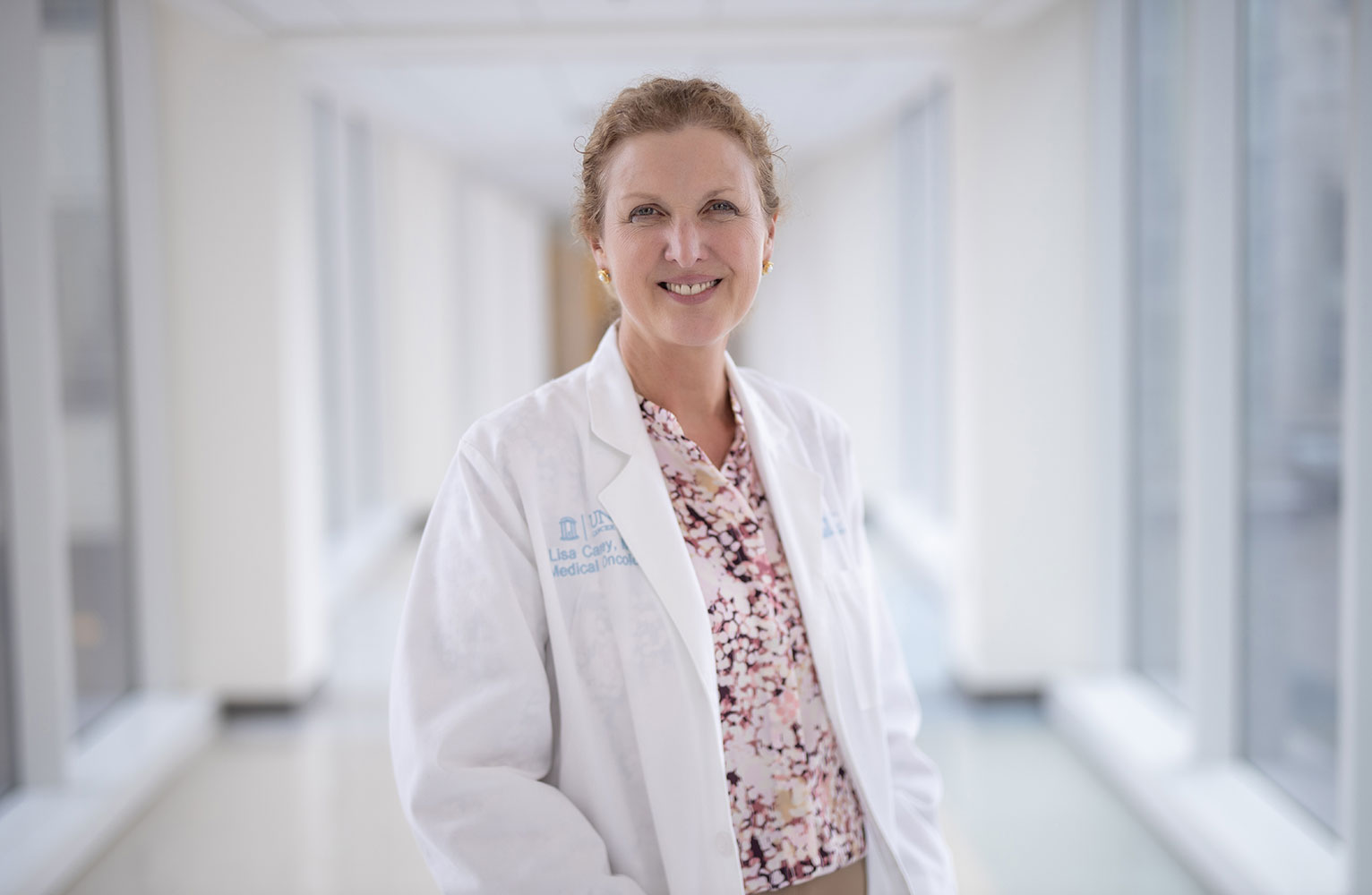 Dr. Lisa Carey poses in a hospital hallway