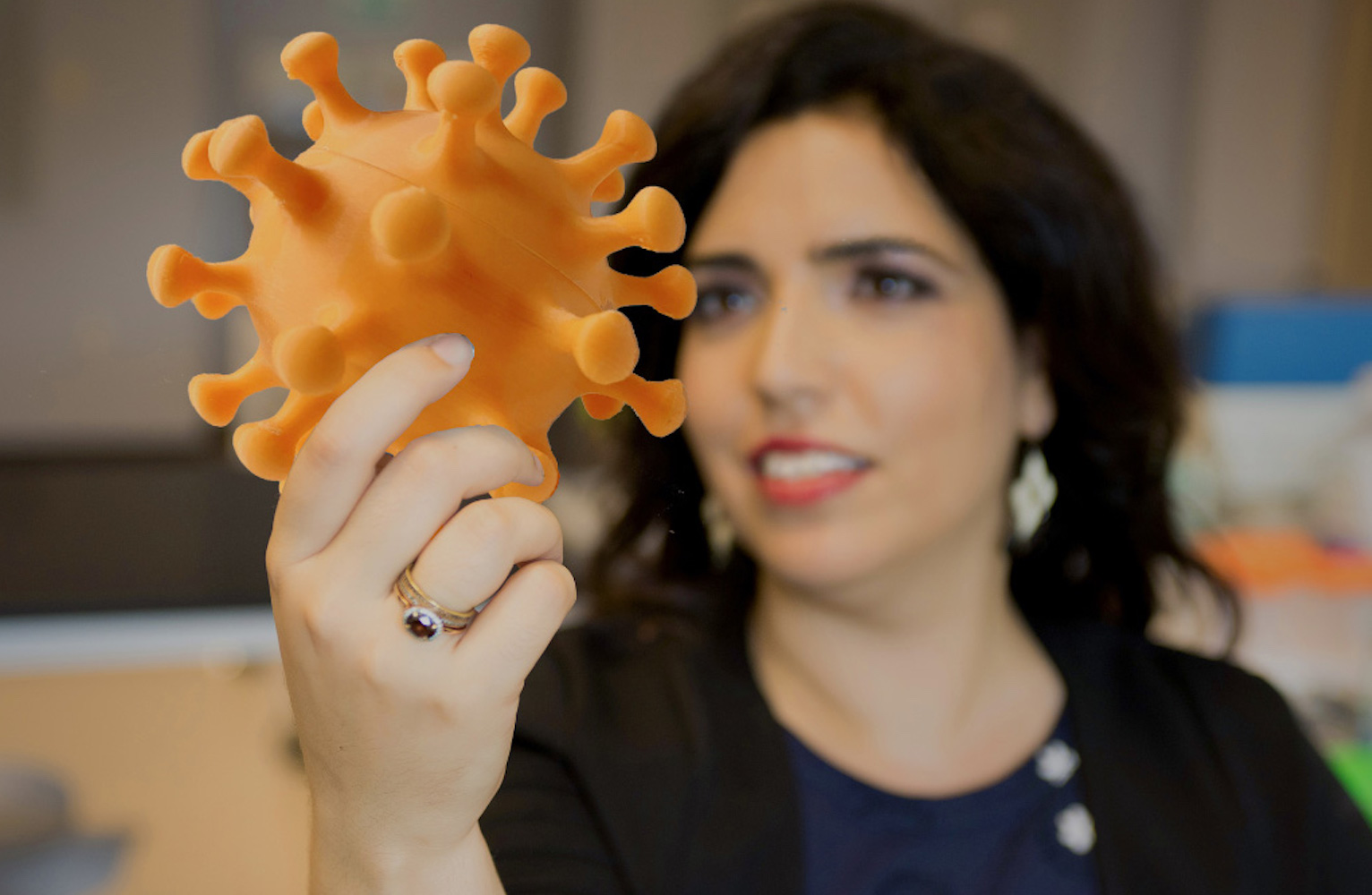 Ronit Freeman holds a coronavirus model
