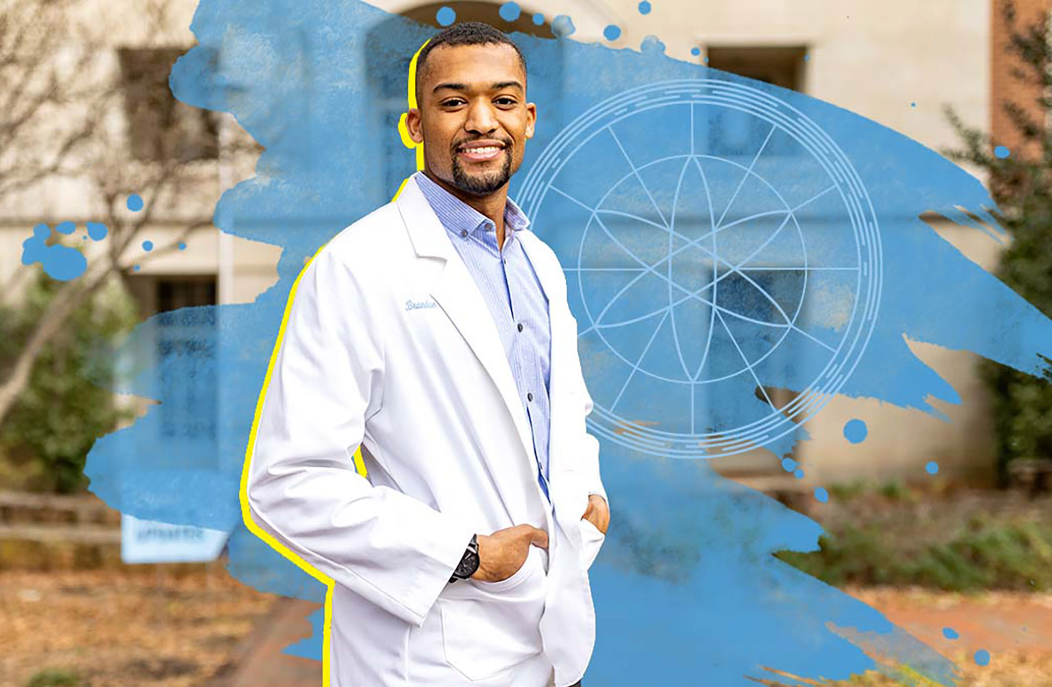 Brandon Feaster in a white lab coat on campus at UNC-Chapel Hill