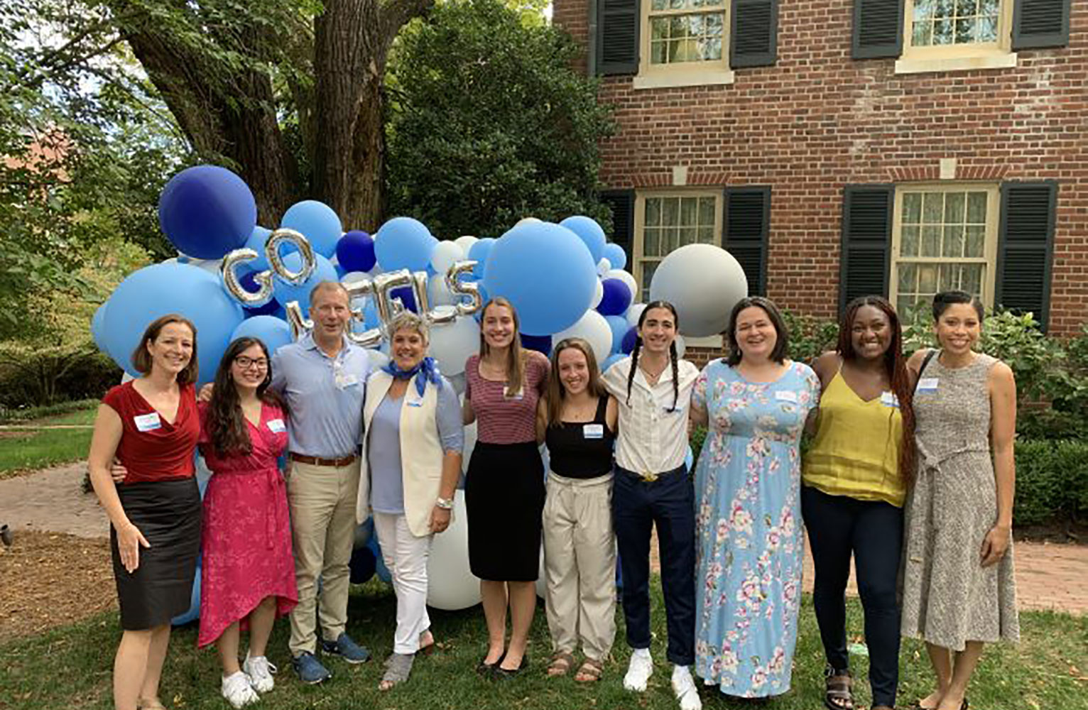 Doug Mackenzie and Dean Terry Rhodes (third and fourth from left) spent time with students at a fellowship gathering in fall 2020.