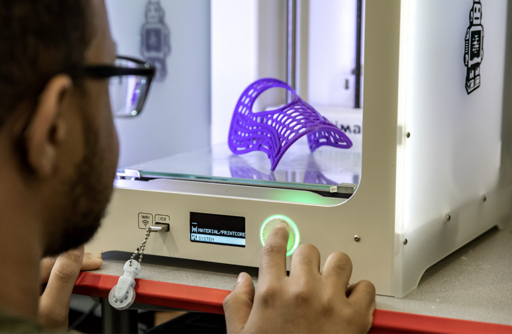 A student uses a 3D printer