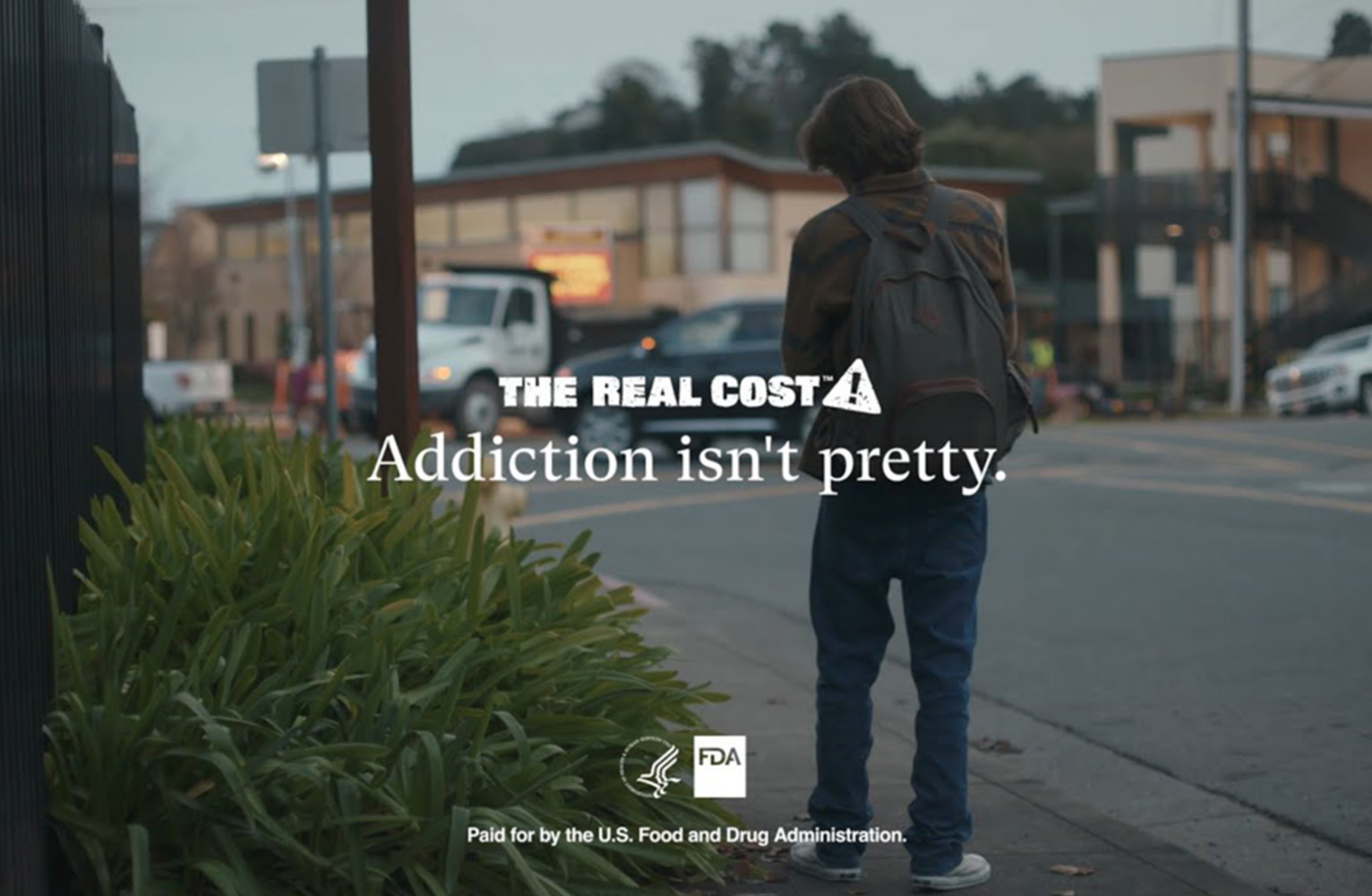 Screencap from a The Real Cost ad, showing a teenager smoking