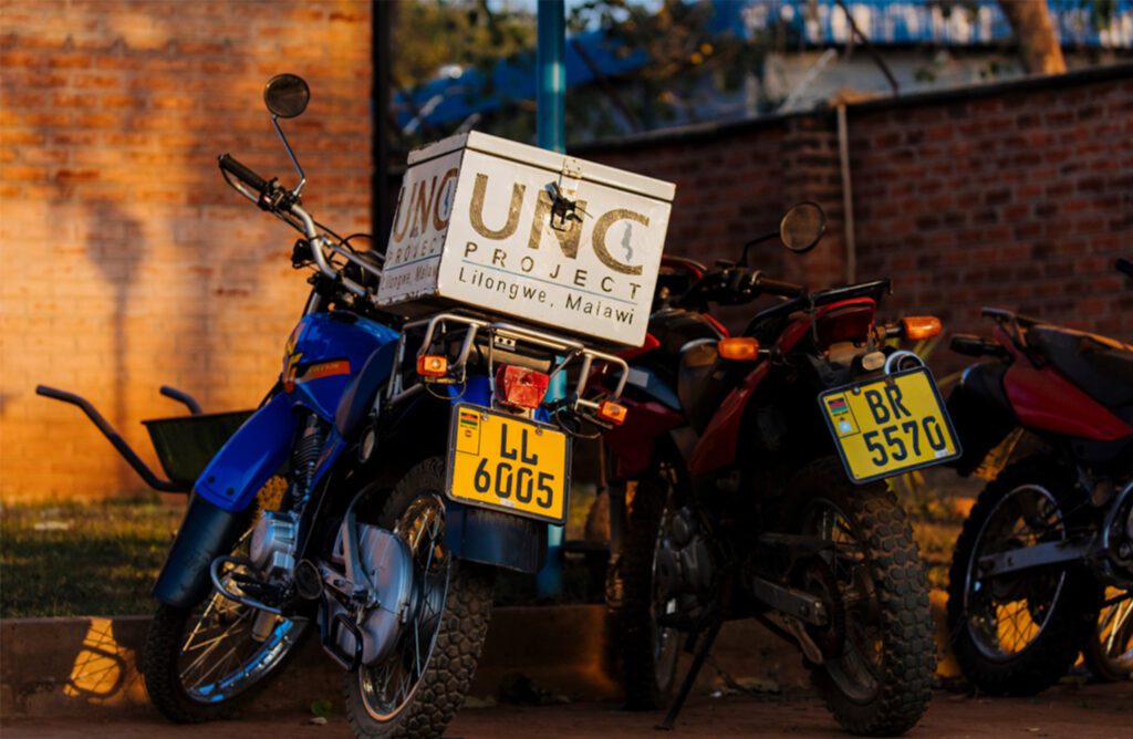 A box on the back of a bike reads UNC Project Lilongwe, Malawi