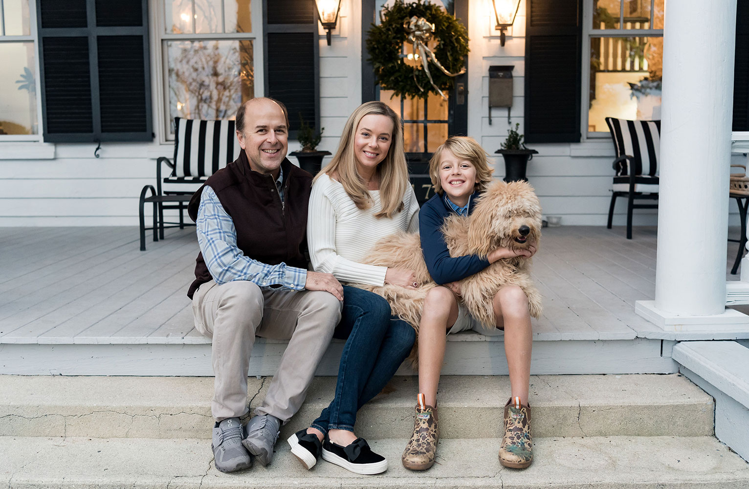 Will Harvey, Kristy Woodson Harvey, son Will Harvey and dog, Salt, pose on the front steps of the Woodson Harvey household in Beaufort, North Carolina